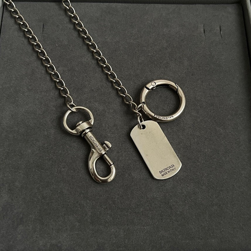 Balenciaga dog-tag keychains with metal rings on silver chains