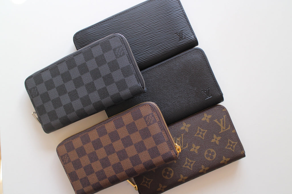 Louis Vuitton small wallets in dark checker, black leather, brown checker, and monogram