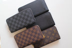 Louis Vuitton small wallets in dark checker, black leather, brown checker, and monogram