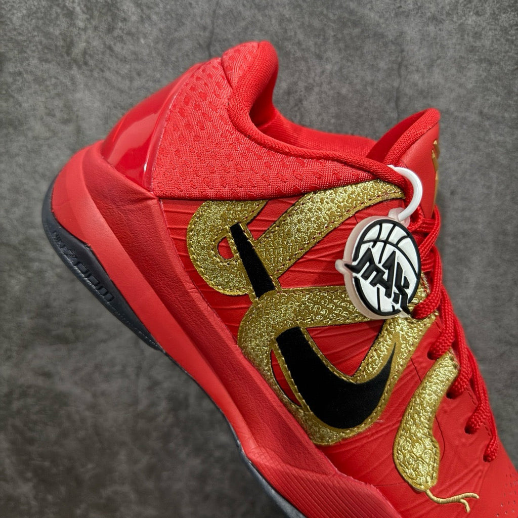 Red basketball shoe quarter view with gold accents and black logo panel