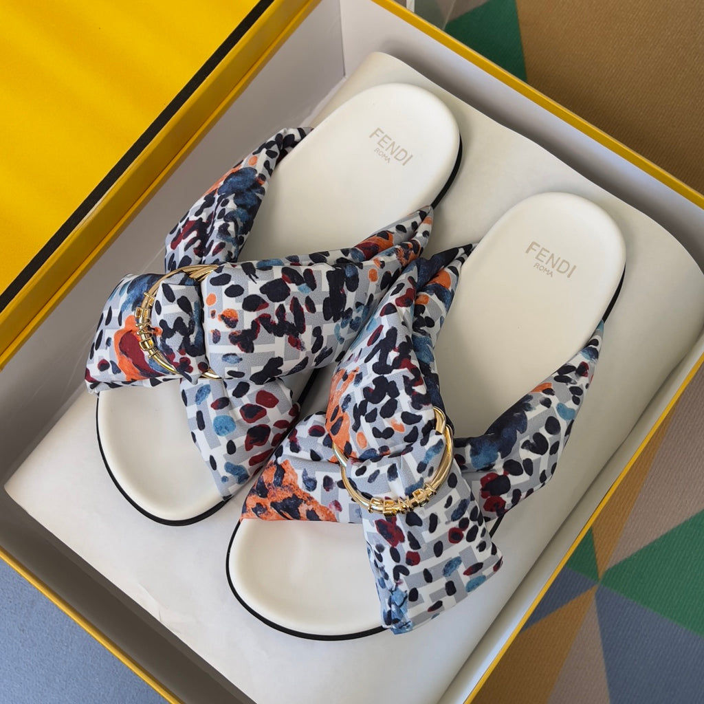 Fendi slide sandals pair with multicolor leopard-print fabric straps and gold-tone buckle details