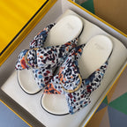 Fendi slide sandals pair with multicolor leopard-print fabric straps and gold-tone buckle details