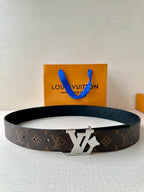 Louis Vuitton monogram belt with dark strap and gold-tone LV buckle
