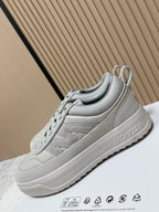 Light gray low-top sneakers with lace-up closure and Moncler branding on side