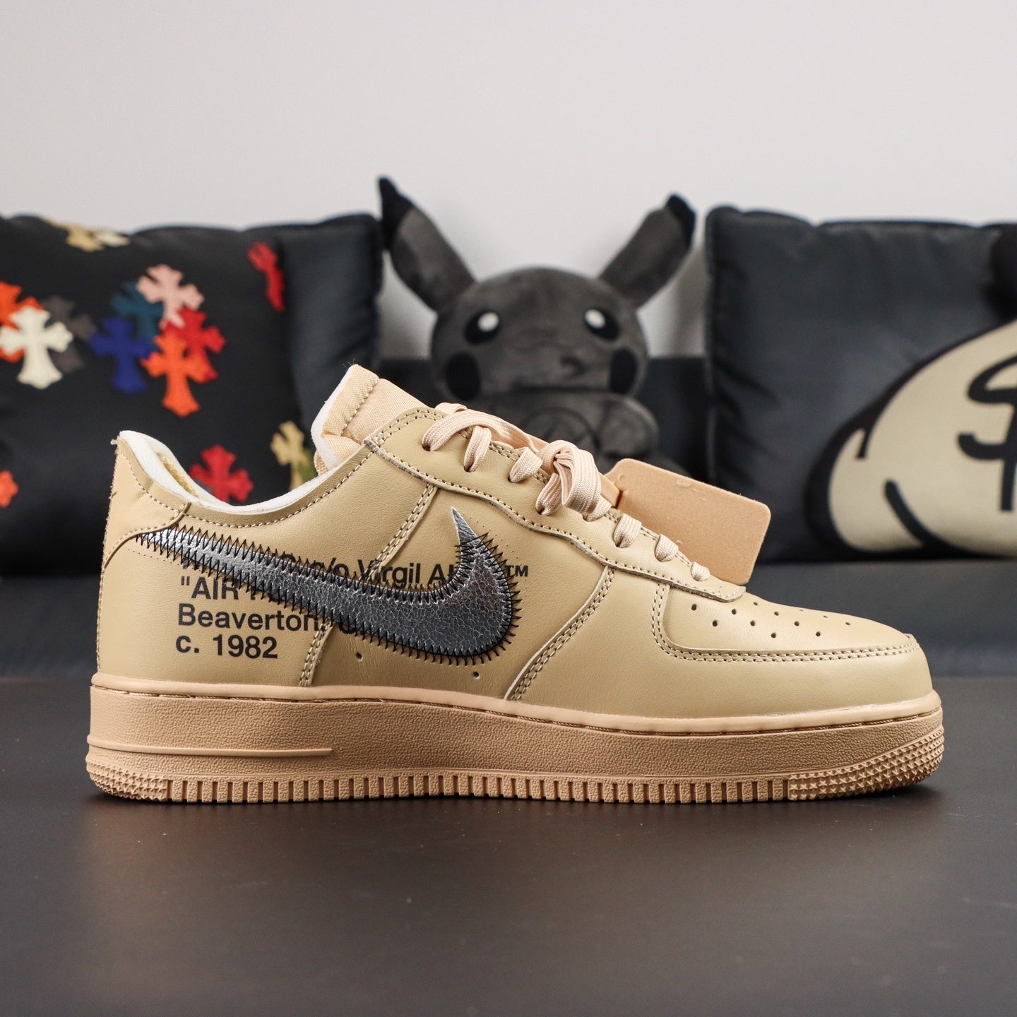 Cream Air Force 1 low-top sneakers with blue Nike swoosh and lace-up detail