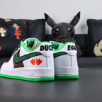 Air Force 1 sneakers, white with green trim; DUCK and EGG on heels; green outsole.