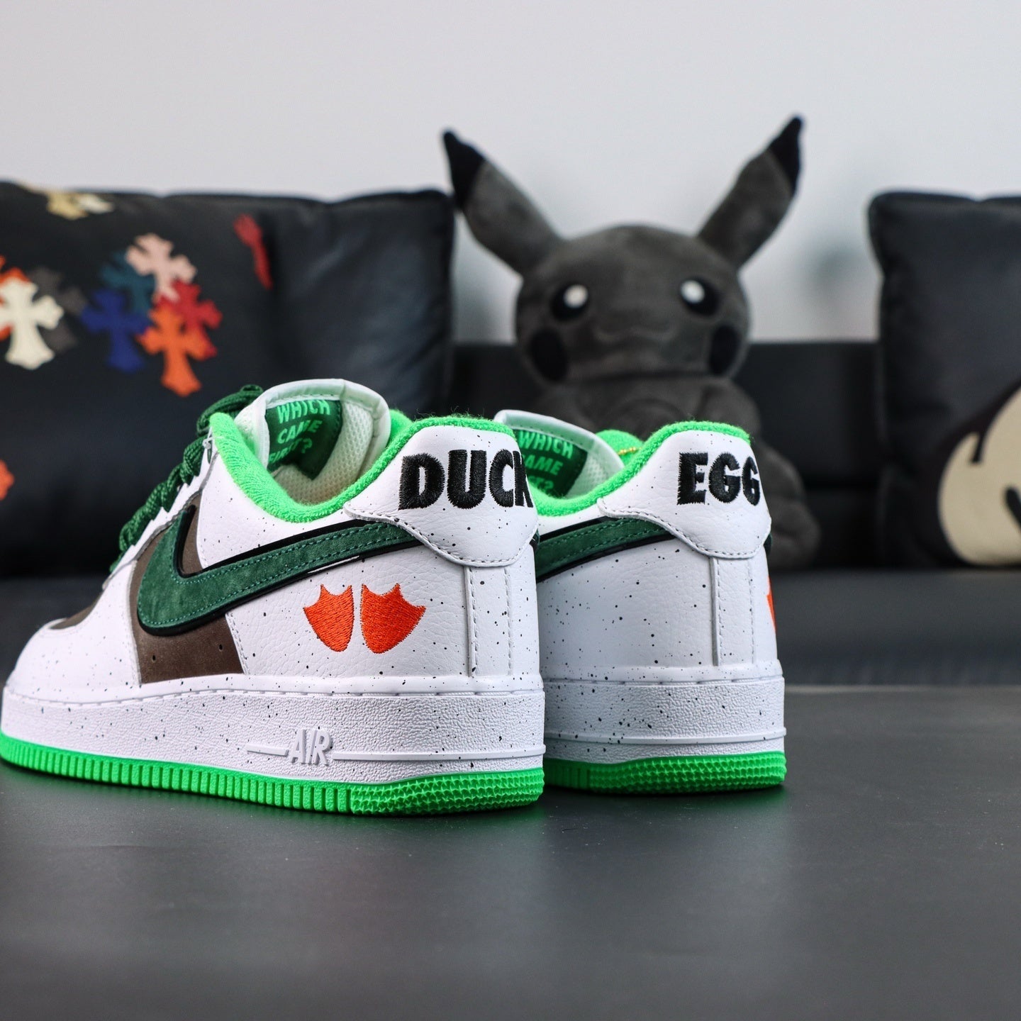 Air Force 1 sneakers, white with green trim; DUCK and EGG on heels; green outsole.