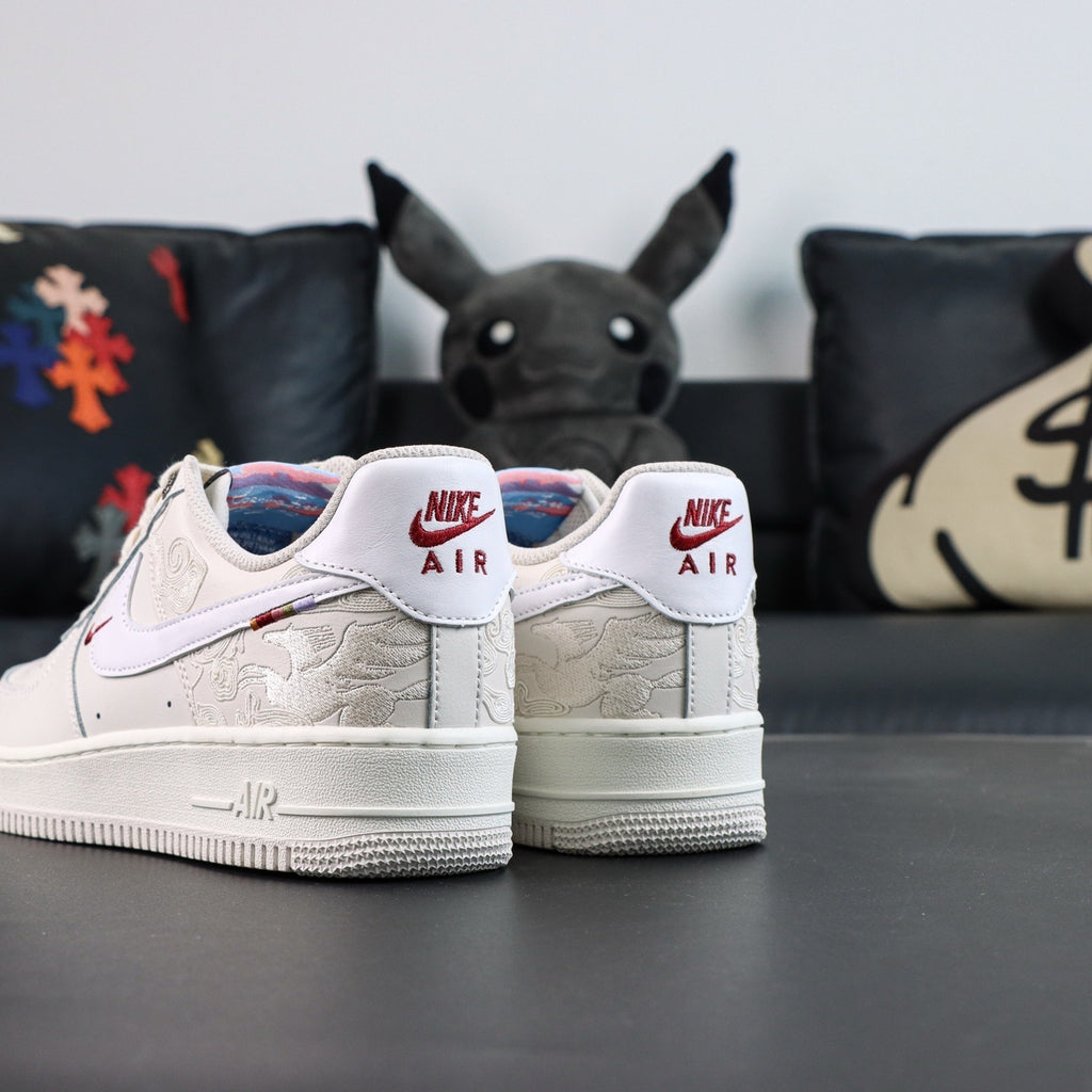 White Air Force 1 low sneakers with Nike Air heel tabs and red swoosh