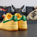 Nike Air Force 1 sneakers, yellow with green collar trim and yellow gum sole
