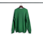 Green crewneck sweatshirt with long sleeves and ribbed cuffs and hem