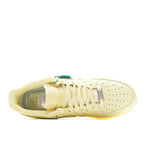 Air Force 1 low-top sneaker in pale yellow leather, lace-up side view with interior lining