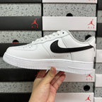 White low-top sneakers with black Nike swoosh and white midsole, side view