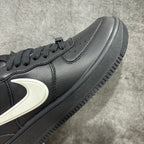 Black leather sneaker side panel with white Nike swoosh and perforated toe area