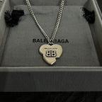 Silver heart charm pendant necklace with BALENCIAGA engraving, shown in box