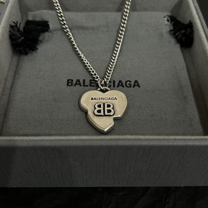 Silver heart charm pendant necklace with BALENCIAGA engraving, shown in box