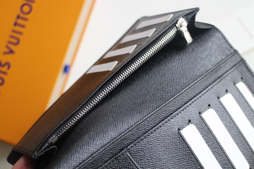 Louis Vuitton small wallet with metal zipper and textured black leather trim