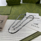 Silver-tone chain necklace with small round pendant and interlocking links