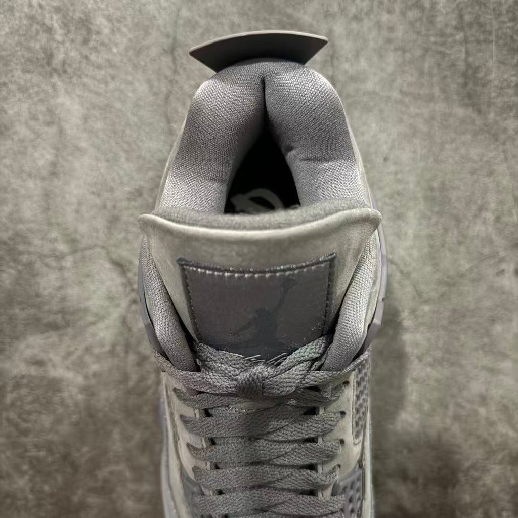 Gray suede sneaker interior opening with cushioned collar and lace loops