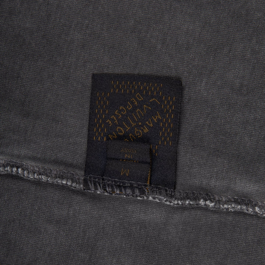Dark fabric patch with Louis Vuitton label and visible stitching