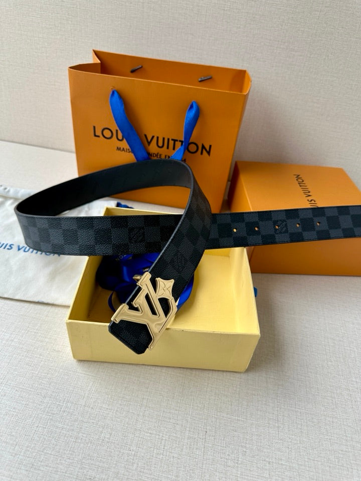 Dark patterned leather belt with LV buckle, shown with accessories in the box.
