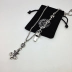 Silver chain necklace with small lock and fleur-de-lis charms, with black pouch