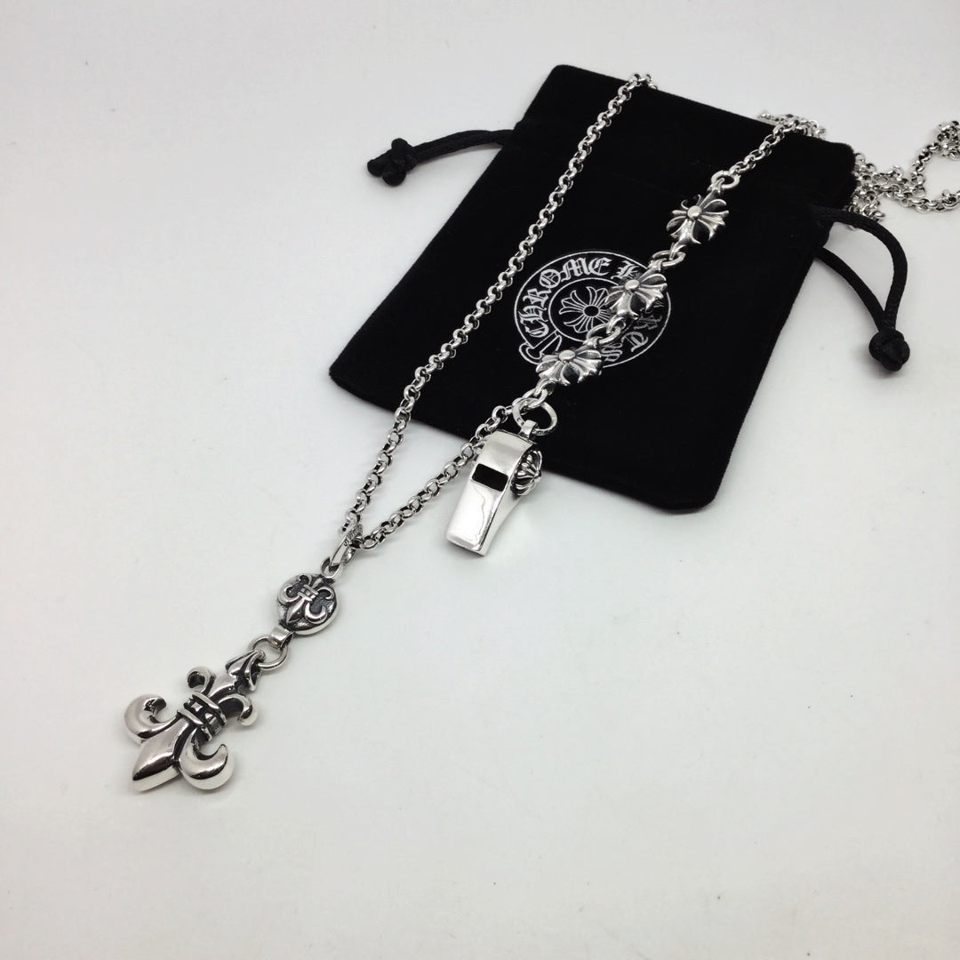 Silver chain necklace with small lock and fleur-de-lis charms, with black pouch