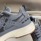 Unisex Dior sneaker upper close-up with padded collar, lace eyelets, and logo tabs.