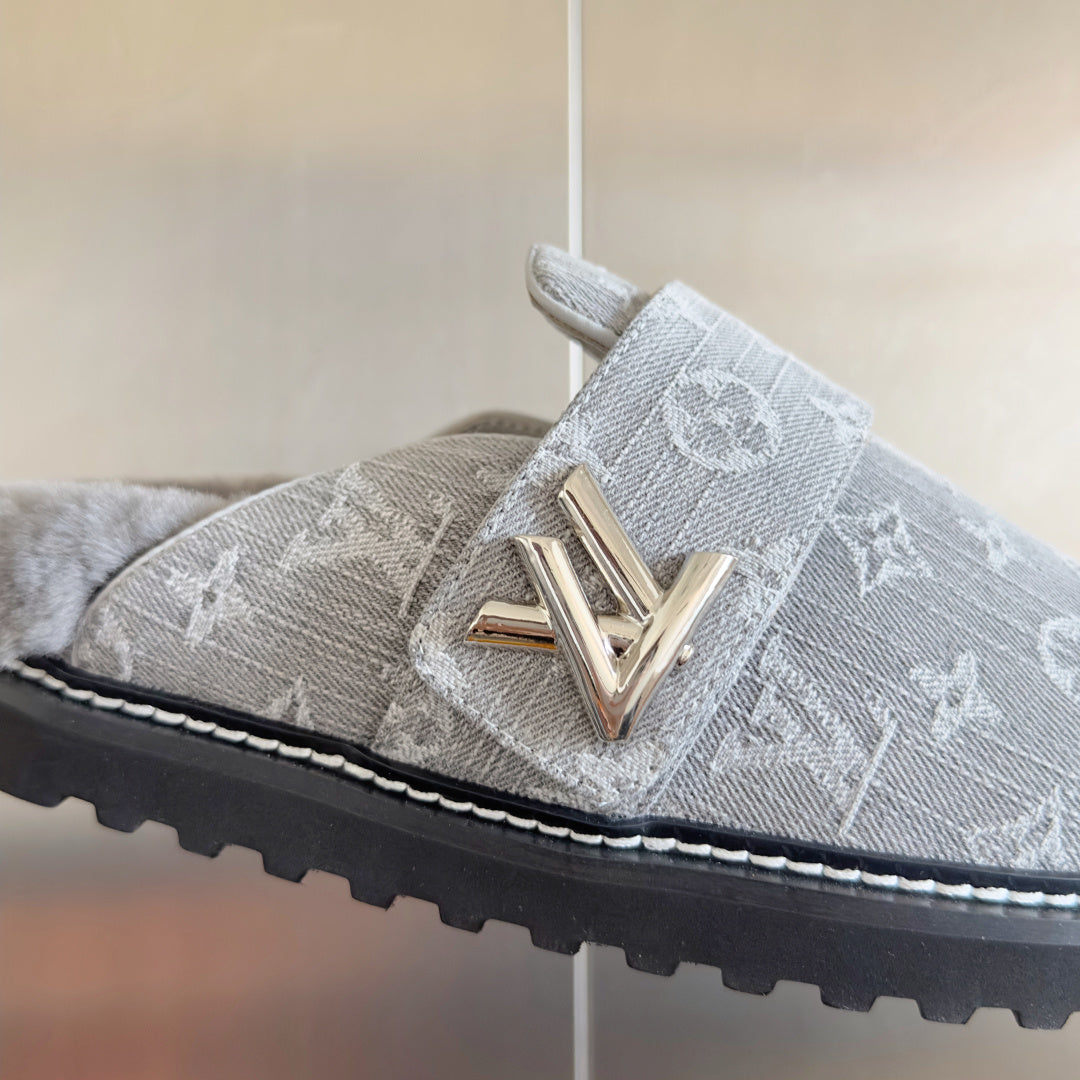 Louis Vuitton slide sandal close-up: gold V buckle on gray monogram strap