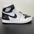 White and black high-top sneakers with black Nike Swoosh and wing logo on collar