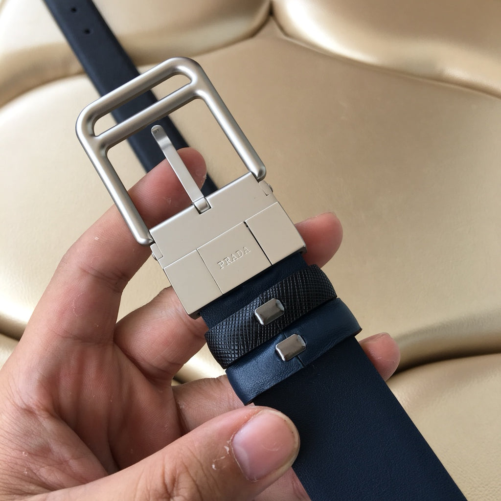 Dark blue belt with silver buckle and dark strap with embossed lettering