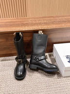 Pair of black mid-calf boots with front buckle strap and sturdy block heel sole.