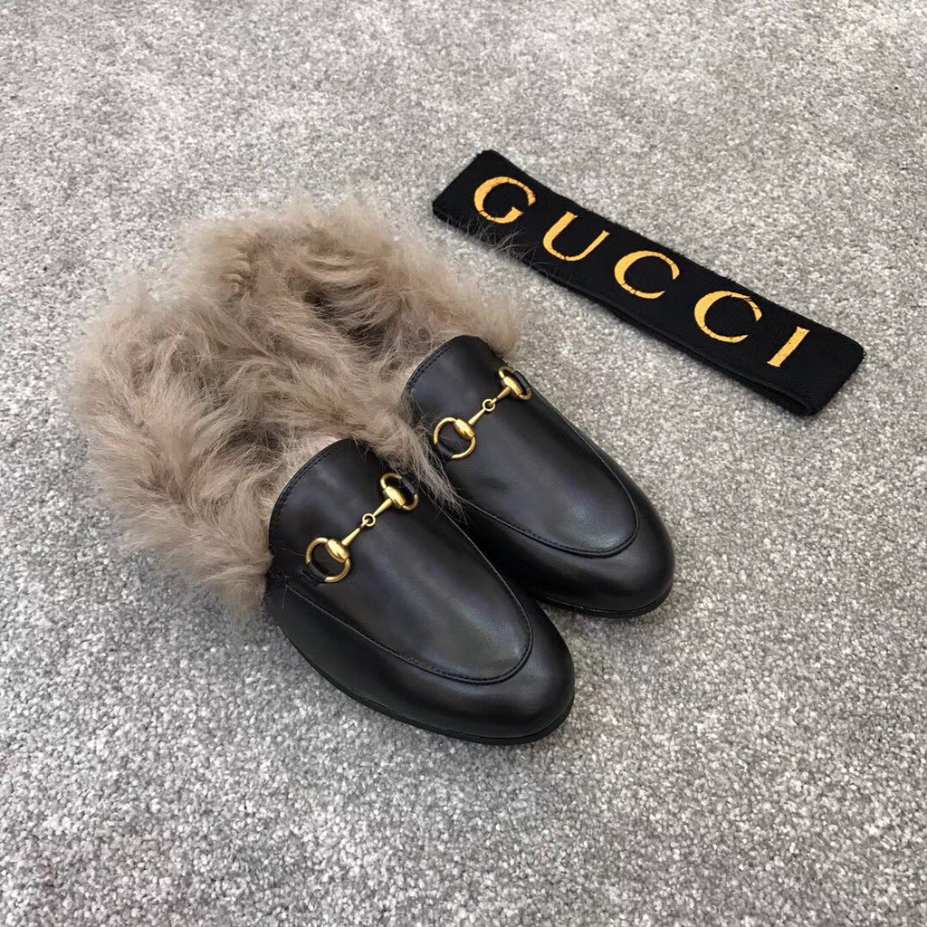 Gucci black slip-on shoes with plush faux fur collar and gold bit detail