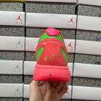 Red sneaker heel with green trim and translucent panel, rear side view