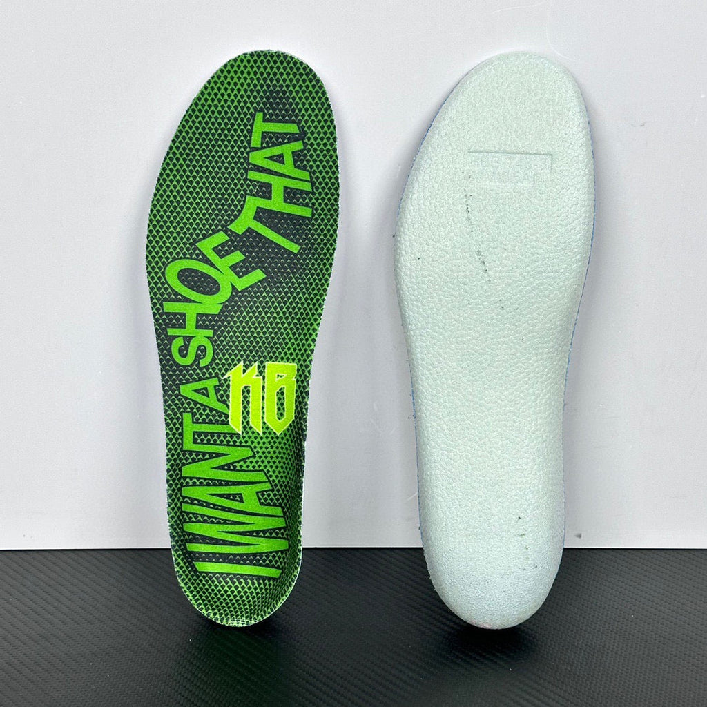 Shoe insoles: white insole sole and green printed insole with partial lettering.
