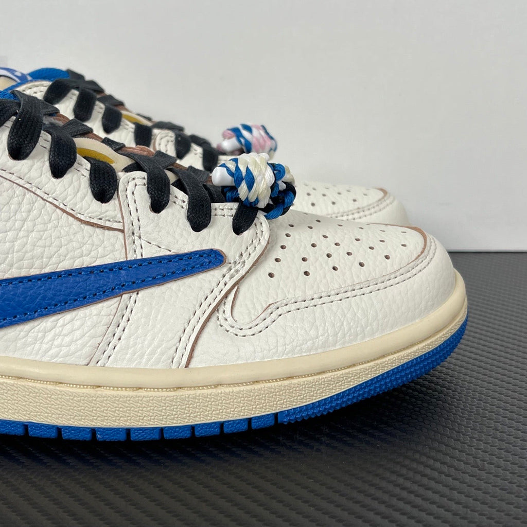 Close-up of white leather sneaker with blue swoosh, black laces, and lace charms