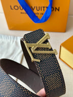 Dark monogram belt with gold rhinestone buckle and textured strap edge detail.