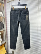 Dark denim trousers with front pockets and stitched crease
