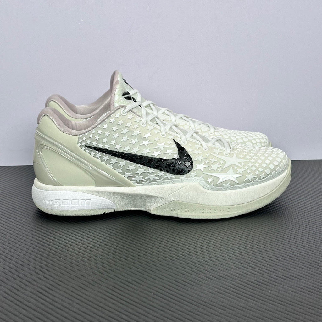 Low-top basketball sneakers, white star-pattern upper, black Nike swoosh, white laces