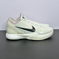 Low-top basketball sneakers, white star-pattern upper, black Nike swoosh, white laces