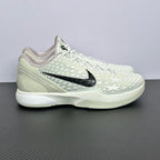 Low-top basketball sneakers, white star-pattern upper, black Nike swoosh, white laces