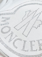 White Moncler T-shirt with rhinestone slogan letters across the front.