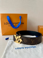 Louis Vuitton monogram belt on cloth with dark strap and gold-tone LV buckle