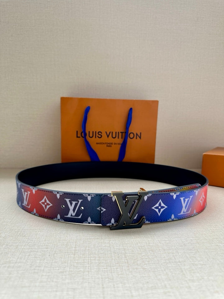 Designer belt with blue monogram print, gold-tone buckle, and black keeper strap