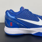 Blue Nike basketball sneaker with white swoosh, red accent, and cushioned sole
