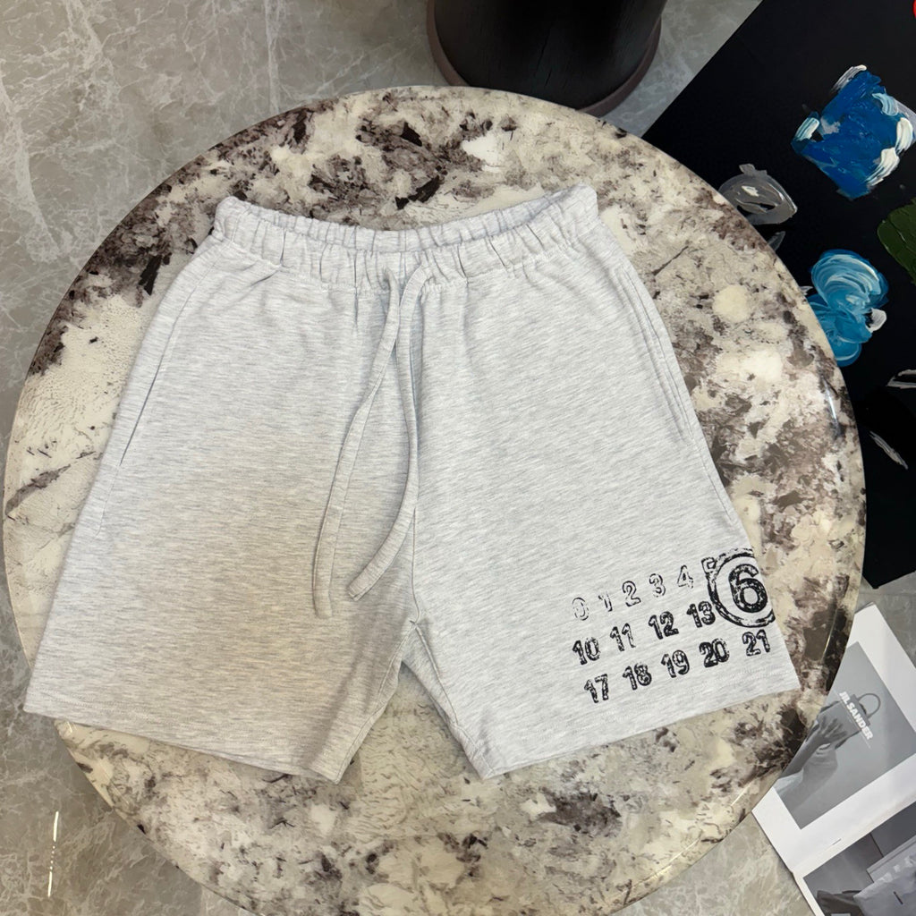 Light gray drawstring shorts with large number graphic on right hem