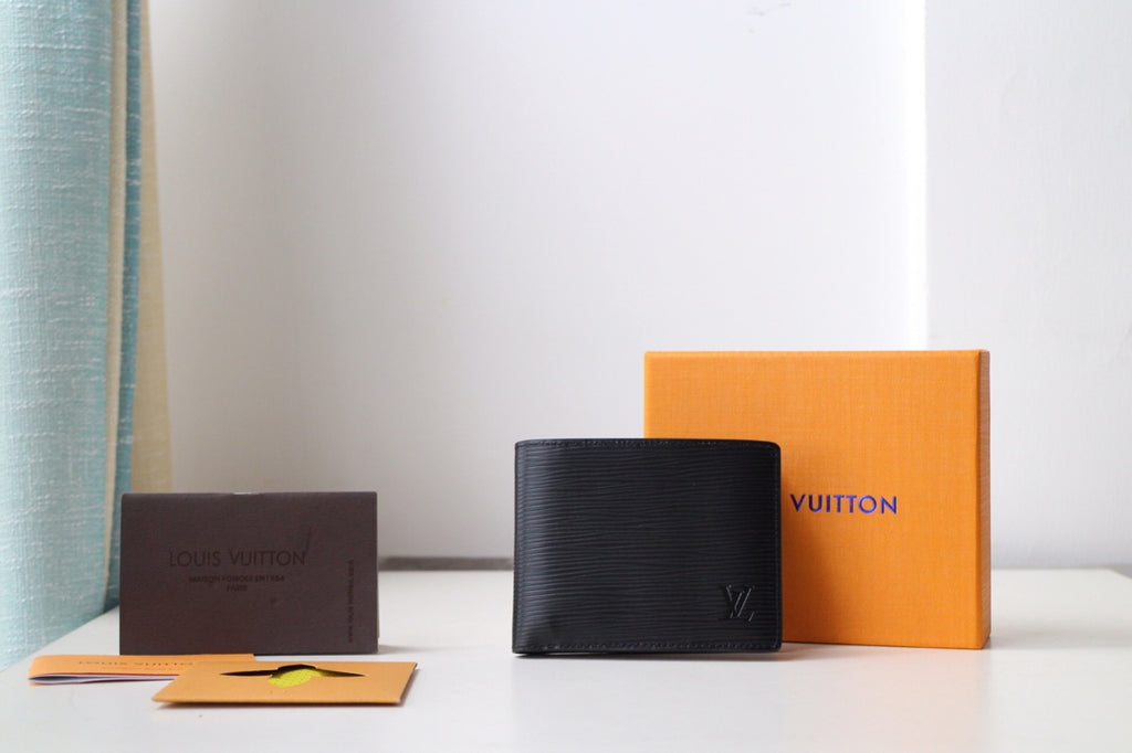Black Louis Vuitton small bag wallet with LV logo on front, textured finish