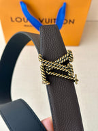 Louis Vuitton belt detail: textured dark leather strap with gold-tone chain buckle