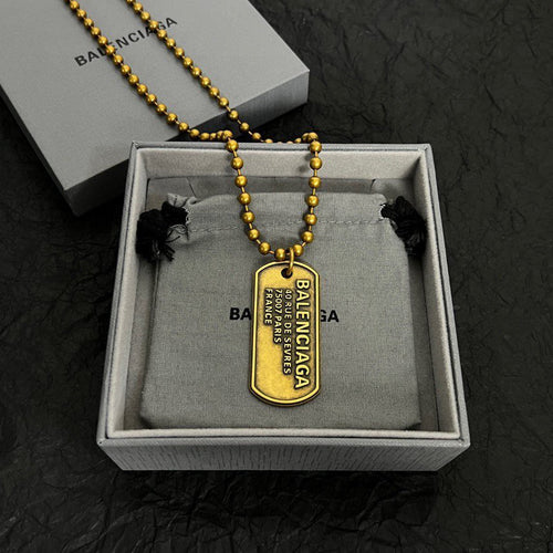 Gold-tone beaded dog tag necklace with Balenciaga pendant