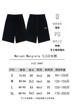 Black shorts product page with size chart and front/back views