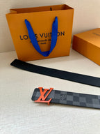 Louis Vuitton long belt with dark checkered strap and orange LV buckle